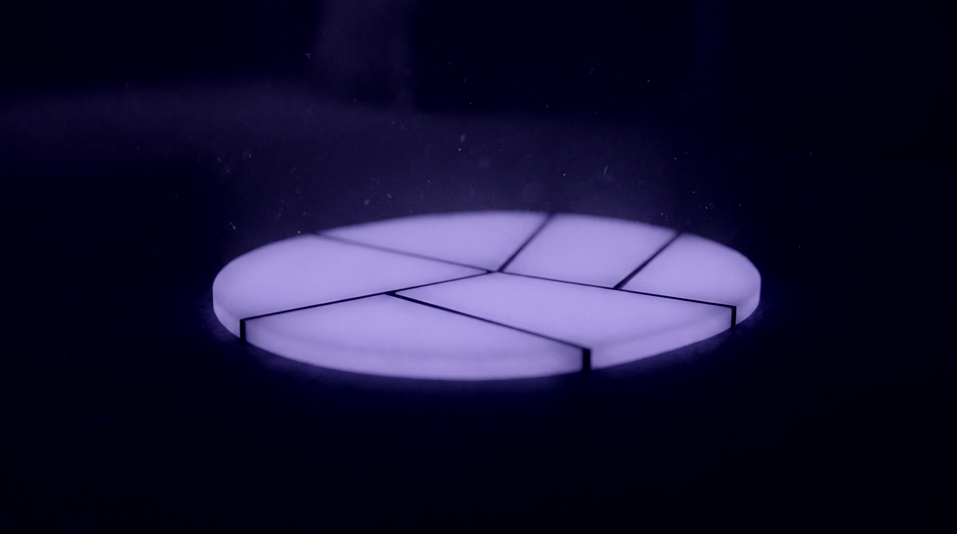 A single lit disc divided into unequal segments
